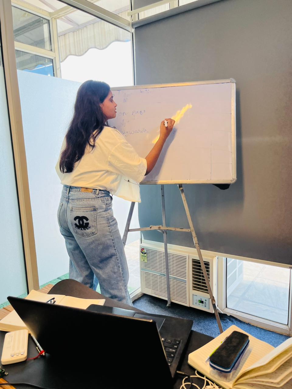 Student writing on whiteboard SEO keywords