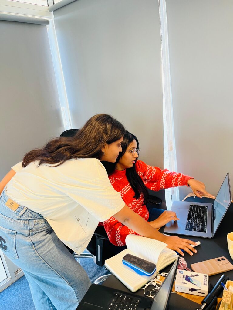 Instructor guiding student on laptop screen